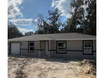 Charming single-story home featuring a neutral color scheme and an attached single car garage at 10538 Se 50Th Ave, Belleview, FL 34420