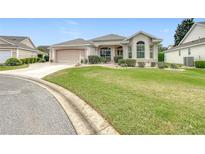 Single-story home with attached garage and landscaped lawn at 7824 Se 166Th Smallwood Pl, The Villages, FL 32162