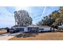 White single story home with carport and spacious yard at 6180 Sw 110Th St, Ocala, FL 34476