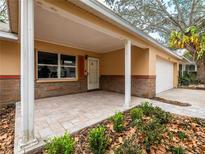 Inviting house exterior featuring a covered porch and a two-car garage at 8626 Sw 97Th Lane Rd # D, Ocala, FL 34481