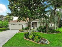 Charming single-story home boasts lush landscaping, a well-manicured lawn, and a welcoming two-car garage at 8990 Se 178Th Muirfield Pl, The Villages, FL 32162