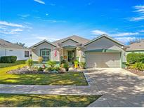 Single-story home with landscaping, driveway, and attached garage at 9470 Sw 66Th Loop, Ocala, FL 34481