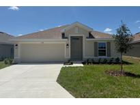 Charming one-story home with a well-manicured lawn and an attached two-car garage at 2154 Nw 23Rd Loop, Ocala, FL 34475