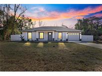 New construction home with gray accents and a fenced backyard at 3690 Se 133Rd Pl, Belleview, FL 34420