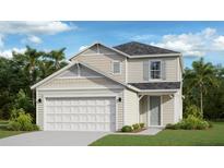 Two-story house with beige siding, gray roof, and a two-car garage at 4021 Ne 31St Ave, Ocala, FL 34479