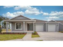 Gray two-car garage home with front porch at 6267 Sw 75Th Court Rd, Ocala, FL 34474