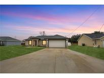 Newly built home with a 1-car garage and spacious driveway at 12 Pine Trace Pl, Ocala, FL 34472