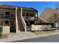 Two-story condo building with stairs and gated entry at 2418 Ne 7Th St # 9, Ocala, FL 34470