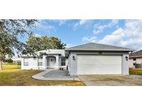 Single-story home with attached garage and landscaped yard at 4945 Nw 33Rd Ln, Ocala, FL 34482