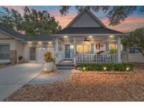 Brick home with covered porch, landscaped yard, and two-car garage at 8540 Sw 90Th Pl # B, Ocala, FL 34481