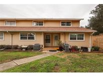 Cozy townhome featuring a well-maintained lawn and classic siding at 11001 Se Sunset Harbor Rd # E 33, Summerfield, FL 34491