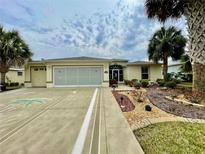Charming home featuring a decorative driveway, tropical landscaping, and a welcoming entrance at 15715 Sw 11Th Terrace Rd, Ocala, FL 34473