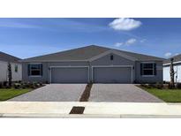 Charming paired villa boasts a brick driveway, well-manicured lawn, and attached two-car garage at 4742 Nw 39Th Street Rd, Ocala, FL 34482