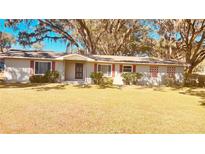 Charming single-story home with a well-manicured lawn and mature trees in a tranquil setting at 691 Se 19Th St, Ocala, FL 34471