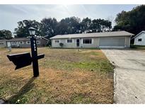 Single-story home with attached garage and lawn at 7632 Sw 112Th Ln, Ocala, FL 34476