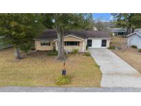 Single story house with driveway and yard at 8111 Sw 108Th Street Rd, Ocala, FL 34481