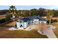 Large home with circular driveway and mature landscaping at 9340 Sw 9Th Ter, Ocala, FL 34476