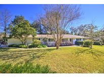 Cute ranch home with a well-manicured lawn and mature trees at 1209 Se 17Th Ave, Ocala, FL 34471