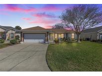 Attractive single-story home with a two-car garage and well-manicured lawn at 17385 Se 110Th Ter, Summerfield, FL 34491