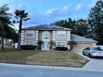 Two-story house with solar panels and a landscaped lawn at 4517 Se 28Th St, Ocala, FL 34480