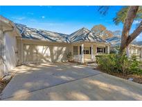 Front view of a single-story home with a carport and landscaped yard at 8681 Sw 93Rd Pl # B, Ocala, FL 34481