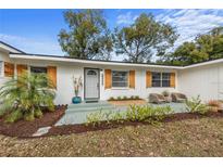 Renovated home featuring a gray front door and updated landscaping at 900 Mulberry St, Fruitland Park, FL 34731