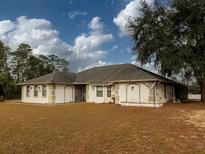 Single-story house with a large backyard and mature trees at 726 Marion Oaks Ln, Ocala, FL 34473