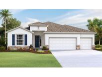 Two-story house with a two-car garage, stone accents, and a landscaped lawn at 3083 Canopy Oak Blvd, Wildwood, FL 34785