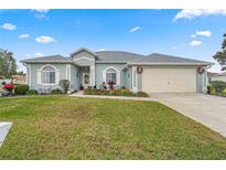 Single-story home with a two-car garage and landscaped front yard at 5908 Nw 24Th St, Ocala, FL 34482
