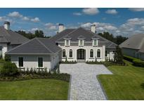 Two-story home with gray stone driveway and landscaped lawn at 7647 Nw 33Rd Pl, Ocala, FL 34482