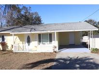 Cute yellow house with carport and white trim at 21465 Sw Honeysuckle St, Dunnellon, FL 34431