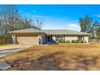 Single-story home with attached garage and yard at 24 Pine Course Pl, Ocala, FL 34472