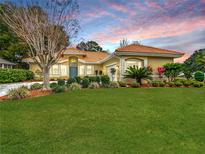 Well-maintained house with a landscaped lawn and a neutral color palette at 8476 Sw 108Th Place Rd, Ocala, FL 34481