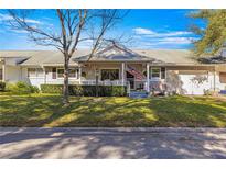 Inviting home exterior with a charming porch and well-manicured lawn at 8677 Sw 95Th Ln # F, Ocala, FL 34481