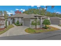 Single-story home with attached garage and landscaped yard at 2021 Se Twin Bridge Cir, Ocala, FL 34471