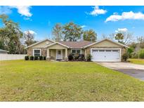 One-story house with stone accents, a two-car garage, and a spacious lawn at 3707 Se 24Th St, Ocala, FL 34471