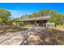 Ranch style home with covered porch and spacious yard at 10425 Se 159Th Lane, Summerfield, FL 34491