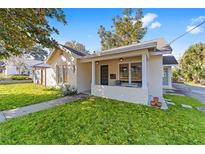 Charming single-story home with a cozy front porch and well-maintained lawn at 114 Ne 11Th Ave, Ocala, FL 34470