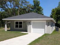 Charming single-story home with well-maintained lawn and attached one car garage at 14259 Se 33Rd Ter, Summerfield, FL 34491