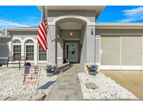 Inviting home exterior featuring a welcoming porch and landscaped walkway at 5137 Nw 20Th Pl, Ocala, FL 34482