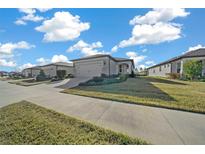 Single-story home with attached garage, landscaping, and a paved driveway at 8958 Sw 57Th Place Rd, Ocala, FL 34481