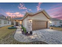 One-story home with brown garage door, stone accents, and landscaped walkway at 9119 Sw 70Th Loop, Ocala, FL 34481