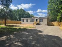 Charming single-story home with fresh gravel driveway and wood accent stairs at 9160 Sw 31St Avenue Rd, Ocala, FL 34476