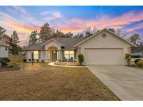 Charming one-story home with a two-car garage and well-manicured lawn at 5077 Sw 107Th Loop, Ocala, FL 34476