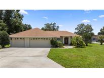 Single-story home with two-car garage and well-manicured lawn at 6558 Se 9Th Pl, Ocala, FL 34472