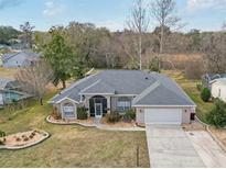 Aerial view of single-Gathering home with large yard and surrounding houses at 7727 Sw 102Nd Loop, Ocala, FL 34476