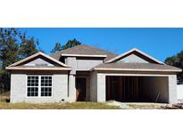 New construction home with gray shingle roof and two-car garage at 7799 Sw 132Nd Pl # 10, Ocala, FL 34473