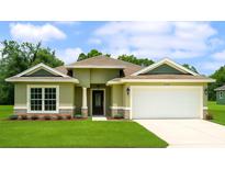 Charming one-story home with green lawn, attached garage, and beautiful stone accents at 7799 Sw 132Nd Pl # 10, Ocala, FL 34473