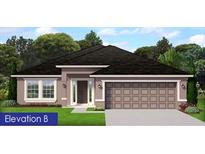 One-story home with a two-car garage and attractive curb appeal at 8797 Se 161St Pl, Summerfield, FL 34491