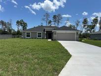 Charming single-story home with a well-manicured lawn and concrete driveway at 10927 Sw 41St Ave, Ocala, FL 34476